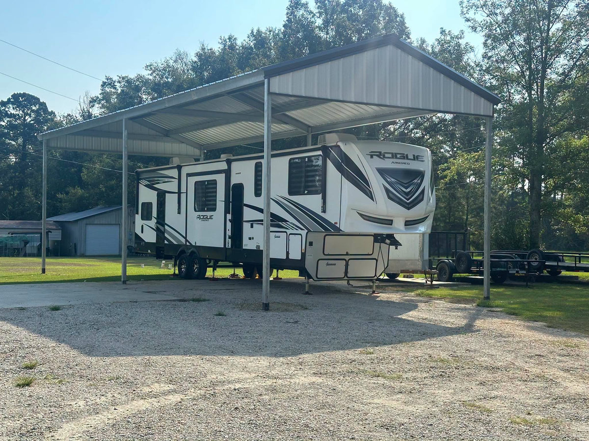 Custom metal RV cover protecting a fifth-wheel camper, built for a residential property by B&J Metal Buildings in South Louisiana.